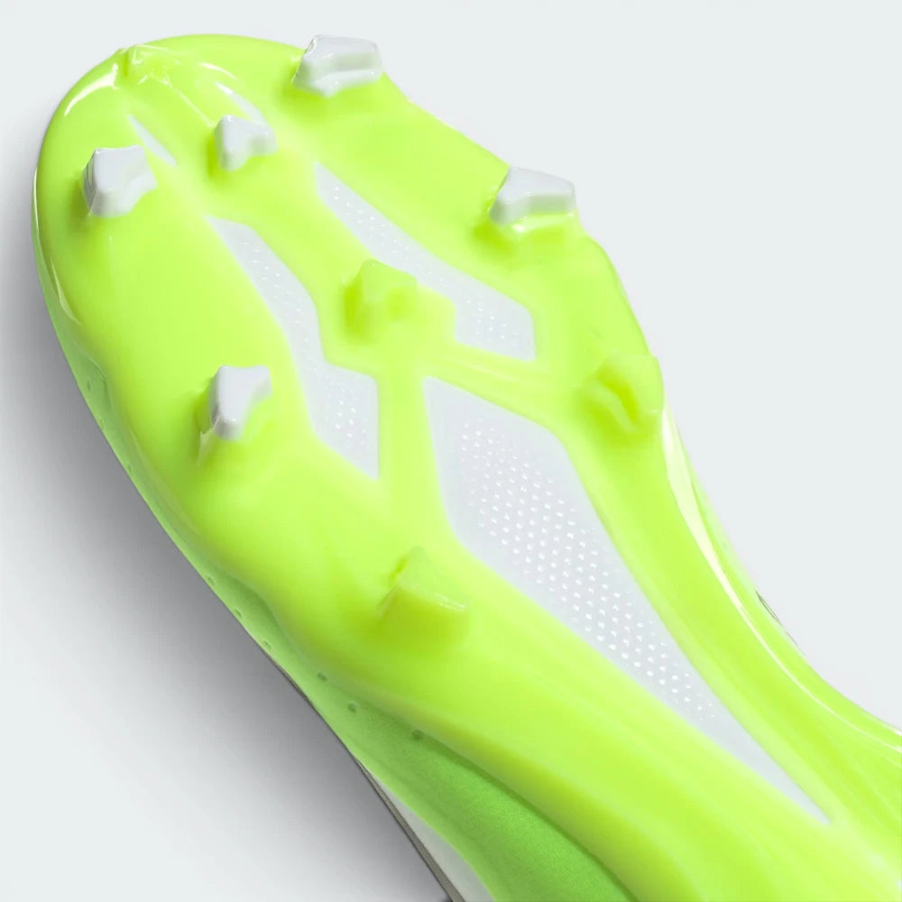 Close-up of a neon green soccer cleat with white studs on a light gray background