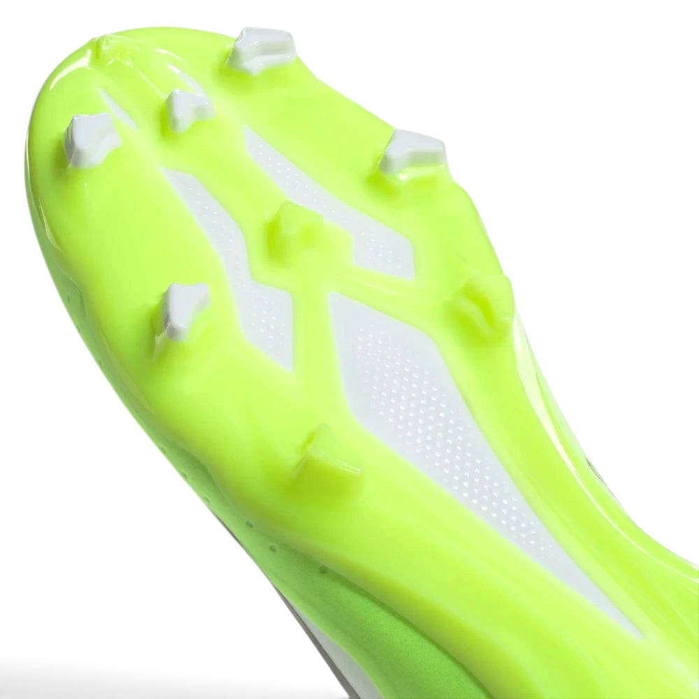 Close-up of a neon green soccer cleat with white studs on a light gray background