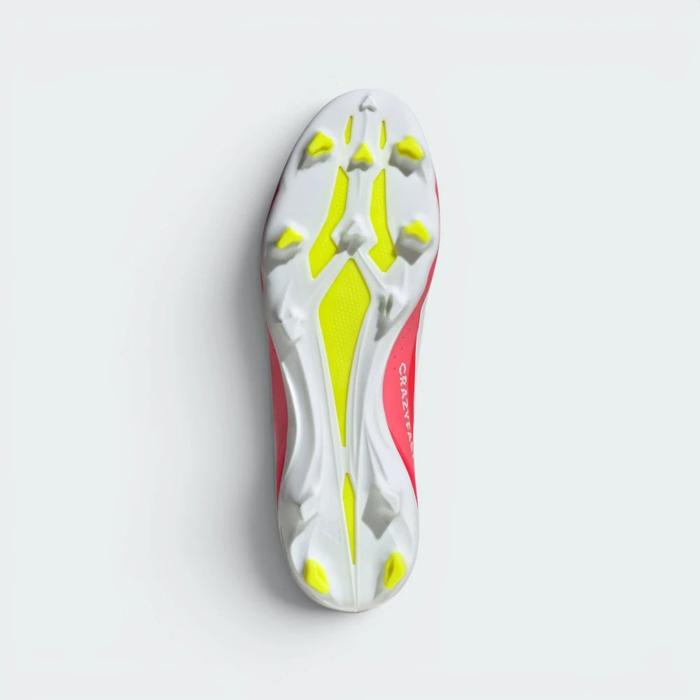 Displays the technical firm ground outsole stud matrix designed for unreal traction and rapid acceleration on dry grass.