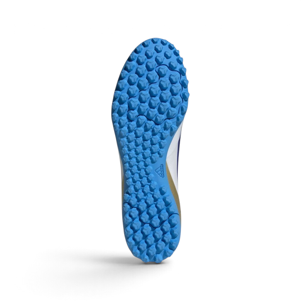Displays the technical lug rubber outsole layout engineered for unreal multi-directional traction on artificial turf.