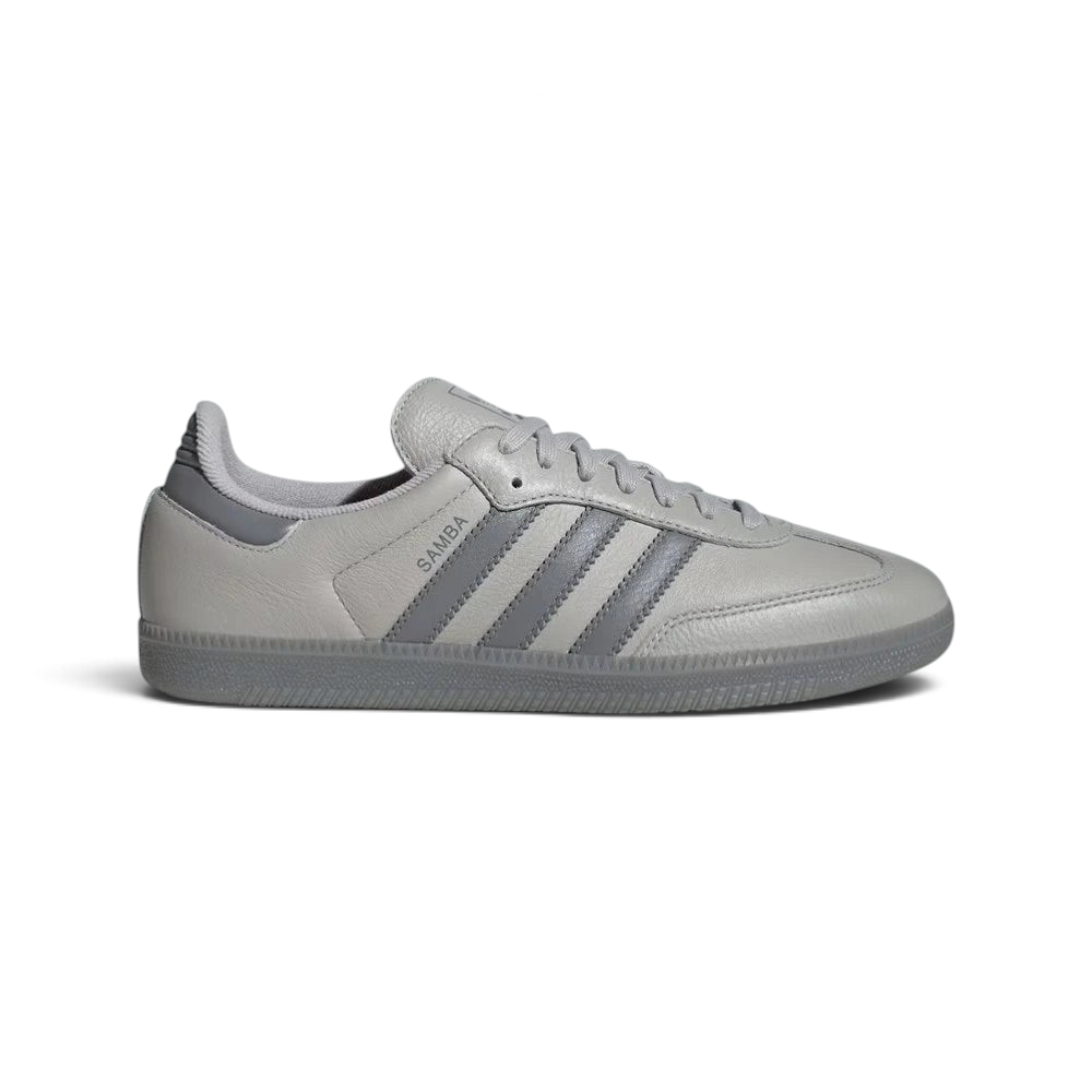 Side profile of the Grey Two Adidas Samba OG, showcasing the tonal grey leather upper and the iconic serrated Three Stripes. Main image