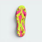 Displays the multi-pitch stud configuration of the firm/multi-terrain sole, showcasing the hybrid molded studs engineered for unreal grip on both natural grass and artificial turf.