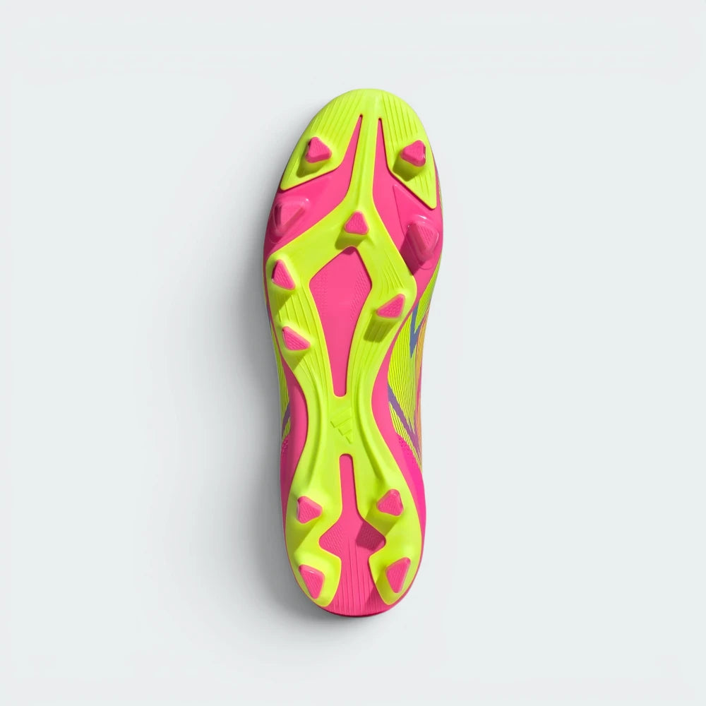 Displays the multi-pitch stud configuration of the firm/multi-terrain sole, showcasing the hybrid molded studs engineered for unreal grip on both natural grass and artificial turf.
