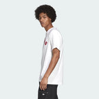 A white Adidas Samstag graphic tee looking from the side