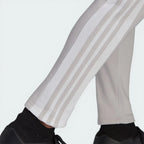 Zoom looking at the open hem cuffs and 3 stripes design