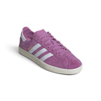 Emphasising the supple, minimalist stance of the trainers and the vivid tonal contrast between the deep royal-purple suede chassis and bright white leather branding panels.