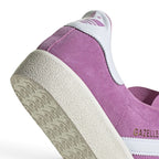 Highlights the "unreal" clean finish of the lateral tooling, showcasing the fine textured sidewall of the rubber cupsole and crisp gilded metallic lettering set against rich purple suede.