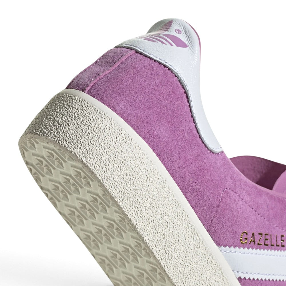 Highlights the "unreal" clean finish of the lateral tooling, showcasing the fine textured sidewall of the rubber cupsole and crisp gilded metallic lettering set against rich purple suede.