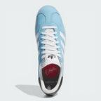 Looking down at the premium suede lacing system and the custom MNUFC x Familia branding on the tongue.
