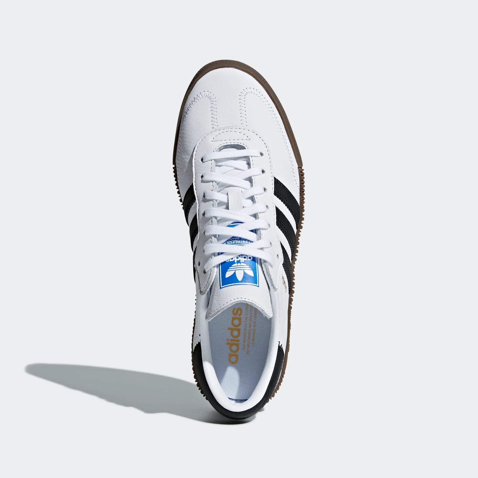 Focuses on the "locked-in" lacing system and the iconic blue rectangle Trefoil badge on the tongue.