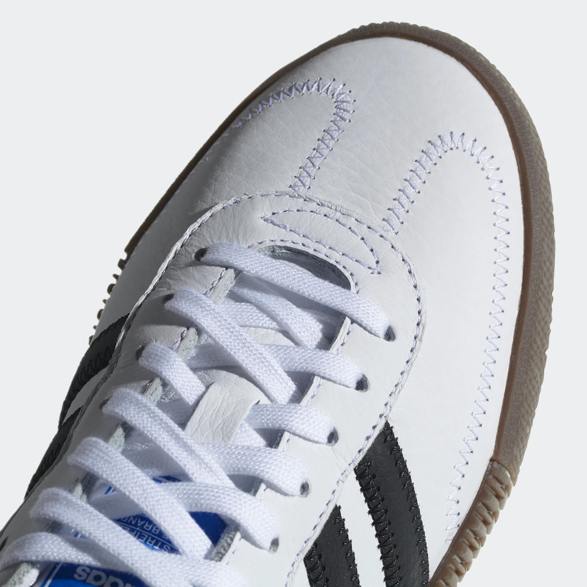 Details the high-definition leather grain texture and the precision of the T-toe overlay.