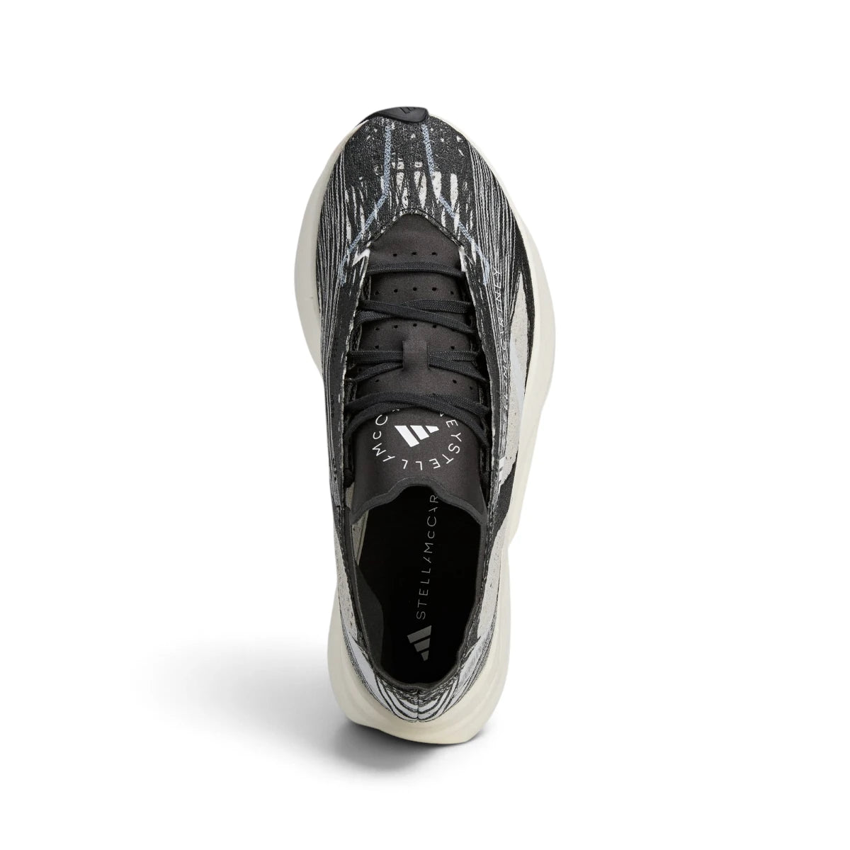 Overhead view looking down at the laced running shoes, displaying the black flat laces, co-branded Stella McCartney tongue badge, and streamlined collar opening.