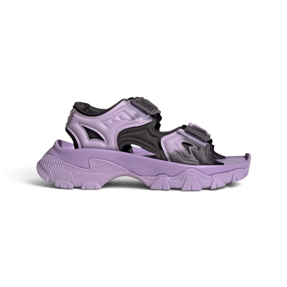 Highlights the high-velocity curves of the chunky, rugged EVA sole unit and the professional layering of the Purple Glow straps. Main image