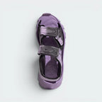 Focuses on the textured contours of the cushioned footbed and the clean alignment of the adjustable velcro straps.