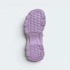 Displays the technical tread pattern of the lightweight sole, engineered for unreal grip on city pavements and seaside dirt trails.