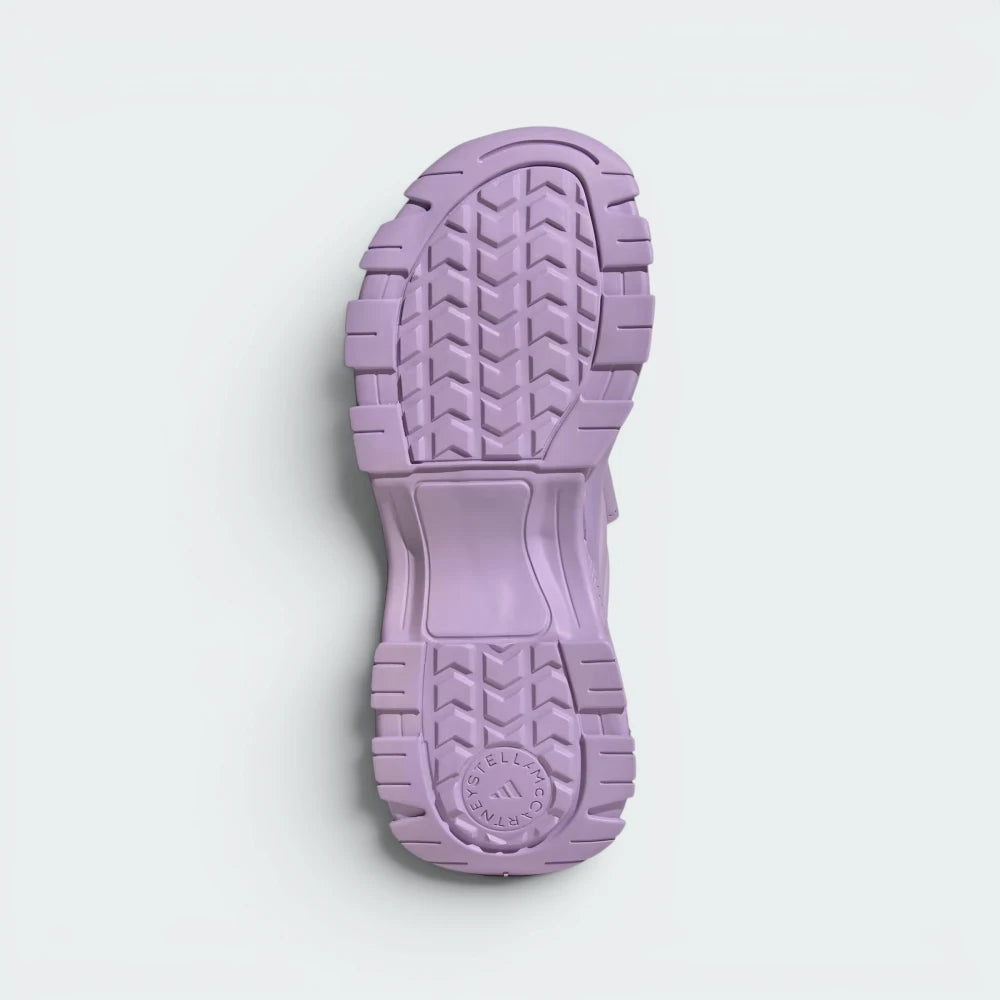 Displays the technical tread pattern of the lightweight sole, engineered for unreal grip on city pavements and seaside dirt trails.