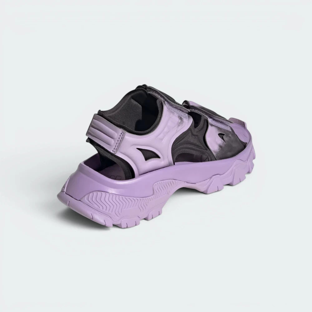 Focuses on the reinforced heel strap layout and the clean finish of the embossed adidas by Stella McCartney logo branding.