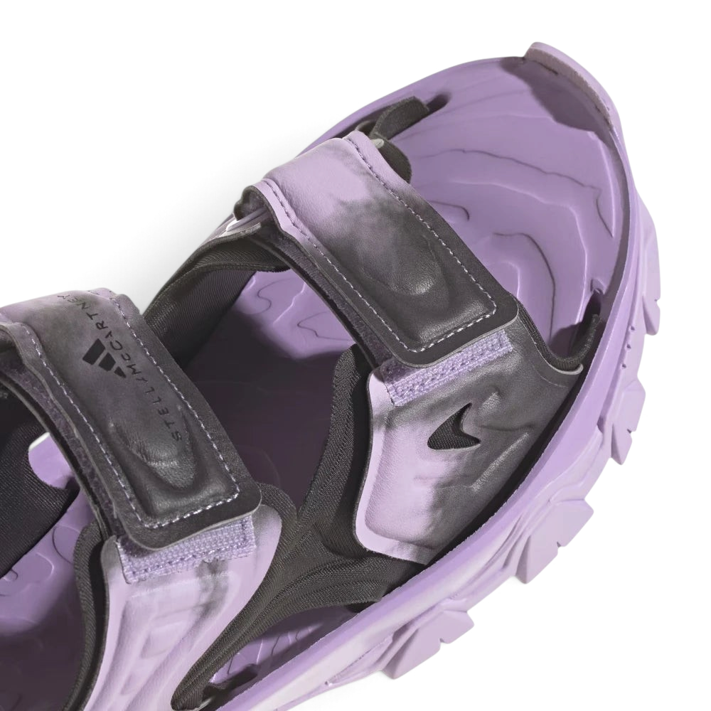 Details the high-definition textile weave of the forward straps and the clean finish of the open toe box design.