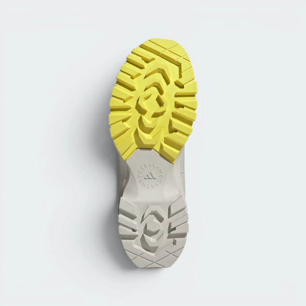 Displays the heavy-duty rubber outsole tread pattern engineered for unreal multi-surface traction on wet, rocky, or icy paths.