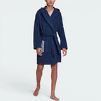 Highlights the clean hem stitching, the unique brand logo at the elbow, and the professional drape of the lightweight Indigo fabric.