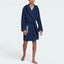 Highlights the clean hem stitching, the unique brand logo at the elbow, and the professional drape of the lightweight Indigo fabric.