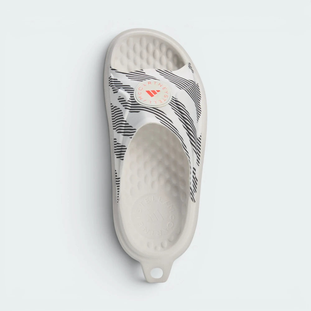 Focuses on the roomy, unrestrictive entry way and the high-definition placement of the crisp adidas by Stella McCartney logo text.