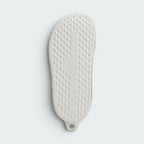 Displays the subtle, technical traction channels engineered for an unreal grip on indoor and outdoor surfaces.