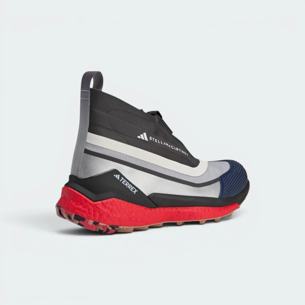 Focuses on the contoured rear ankle support structure and the premium finish of the Stella McCartney logo heel pull.