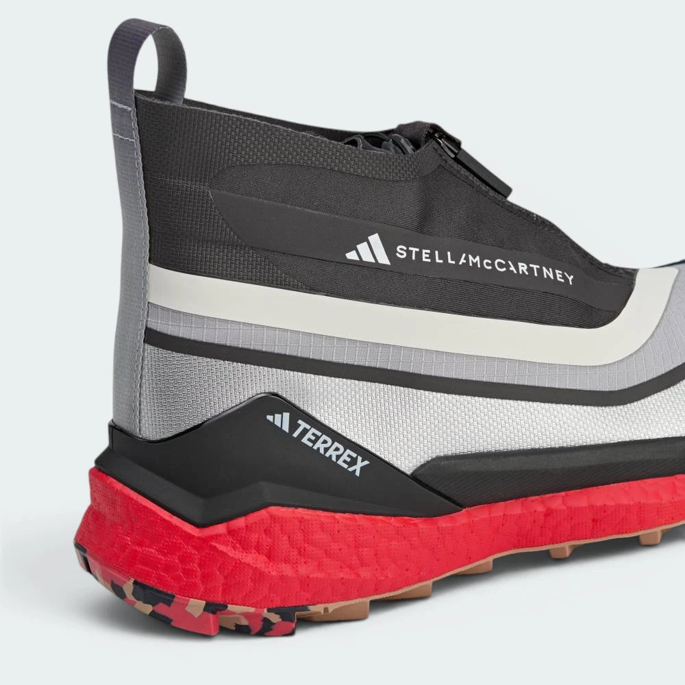 Highlights the "unreal" textured finish of the responsive Red Boost cushioning tightly bonded to the camo rubber foundation.