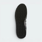 Displays the technical rubber tread designed for unreal retro-running traction.