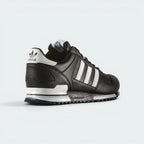 Focuses on the total heel stabilizer and the professional finish of the adidas Trefoil logo.