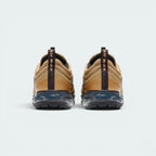 Focuses on the contoured shape of the gold heel strip, showcasing the vertical Varsity Red "VaporMax" branded pull loop rising cleanly from the sole.