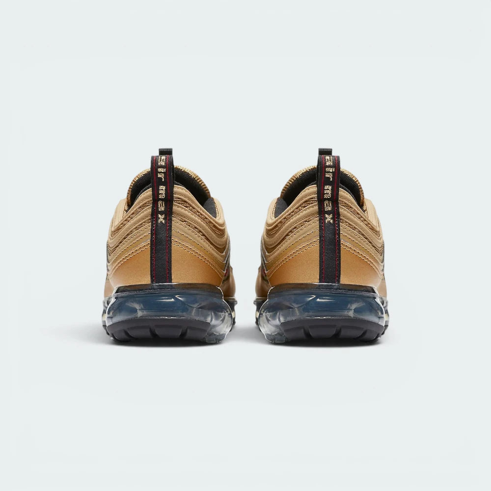 Focuses on the contoured shape of the gold heel strip, showcasing the vertical Varsity Red "VaporMax" branded pull loop rising cleanly from the sole.