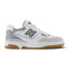 Displays the full lateral silhouette featuring the crisp white full-grain leather upper, perforated midfoot panels, Brighton Grey suede toe bumper, puffed two-tone 'N' logo with Nori green border, stitched white midsole, and gum rubber outsole rim.