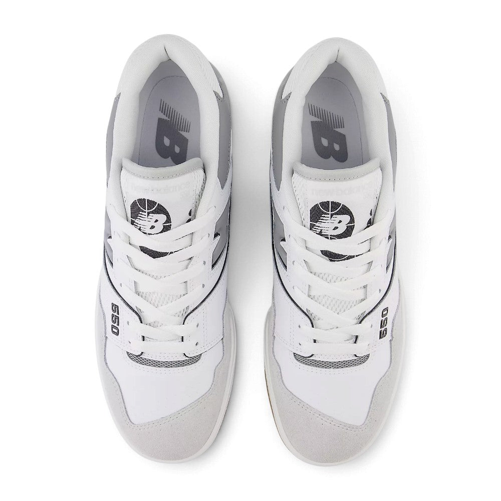 Direct overhead view of both shoes laid flat, showcasing the Brighton Grey suede toe overlay, perforated leather vamp, flat white laces threaded through reinforced eyelets, padded mesh tongue with basketball graphic crest badge, and cushioned comfort sockliner.