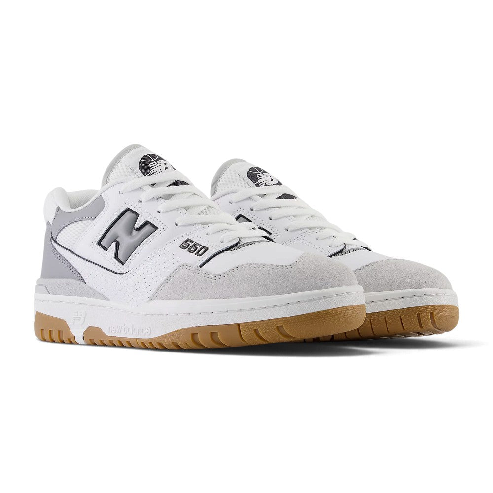 Forward three-quarter angle showcasing both shoes side by side, highlighting the chunky 1989 court stance, layered leather and suede texture depth, puffed branding accents, and clean retro silhouette.