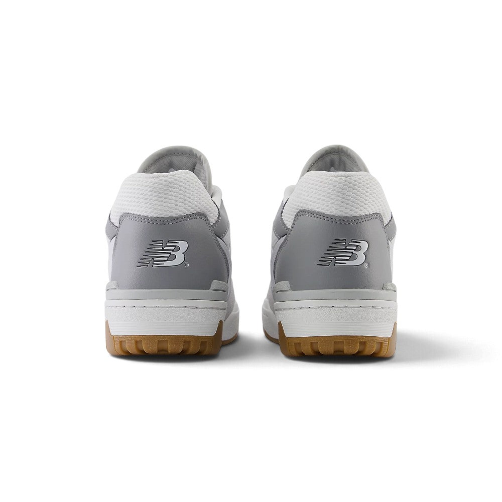 Close-up rear angle focusing on the structured white leather heel counter, Nori green and Brighton Grey textile collar inserts, embroidered Flying 'NB' logo, and solid rubber cupsole base.