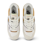 Focuses on the locked-in central lacing layout, displaying the symmetry of the white mesh tongue, matching laces, orange basketball tongue tag graphics, and black "NB" branding printed on the grey insoles.