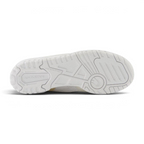 Displays the full-length non-marking solid white rubber sole, showcasing the classic court pivot-circle grid and debossed "new balance" branding.