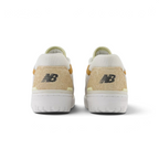 Focuses on the rear profile of both heels, highlighting the tactile hairy suede heel counters, black embroidered "NB" logos, and the sturdy white rubber sole base.