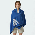 Person wearing a blue Adidas towel on a white background