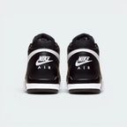 Focuses on the contoured shape of the padded mid-cut collar, highlighting the seamless black leather heel cup and the clean, wide footprint of the sole unit below.