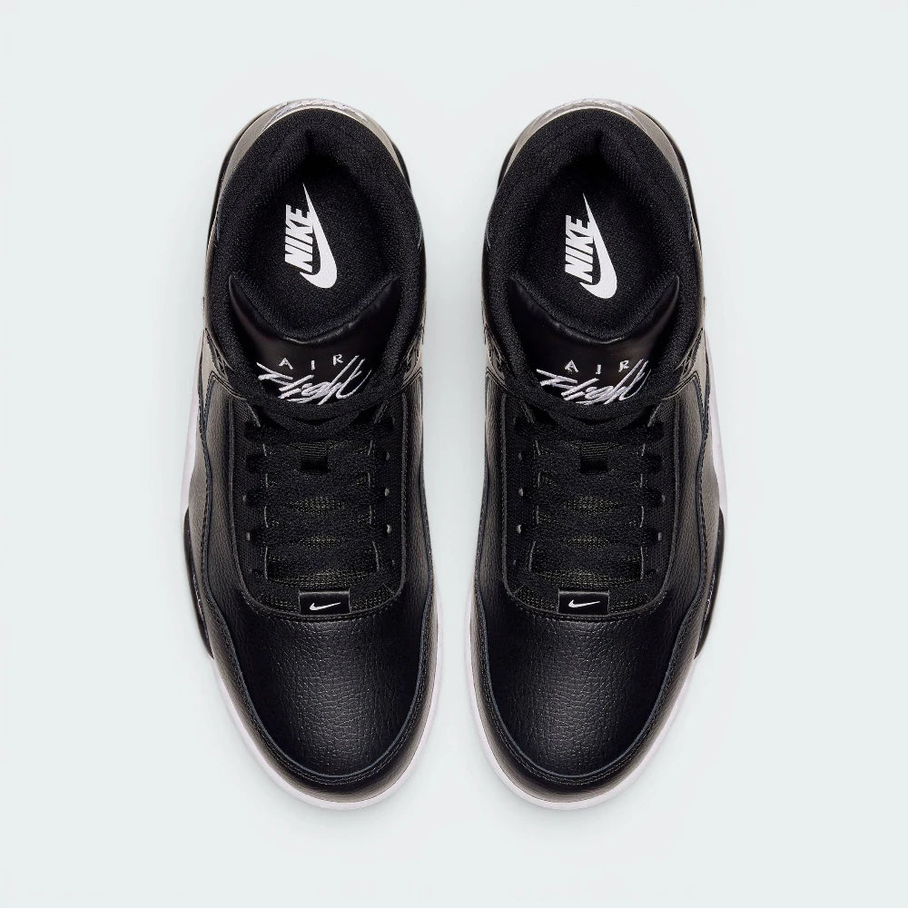 Focuses on the locked-in traditional lacing layout, displaying the perfect symmetry of the black leather tongue, matching black laces, and the white embroidered "Flight" logo script.