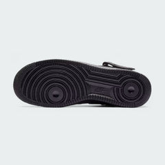 View of the outsole of the Nike Air Force 1 Mid '07 Men's black trainers, showing the durable rubber sole and pivot circles for traction.