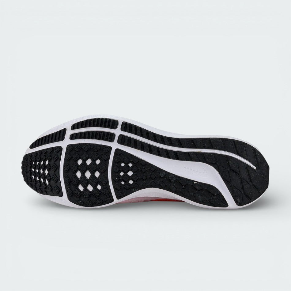 Detailed view of the Nike Air Zoom Pegasus 39 outsole, showing the black rubber waffle tread and orange flex grooves for multi-surface grip.