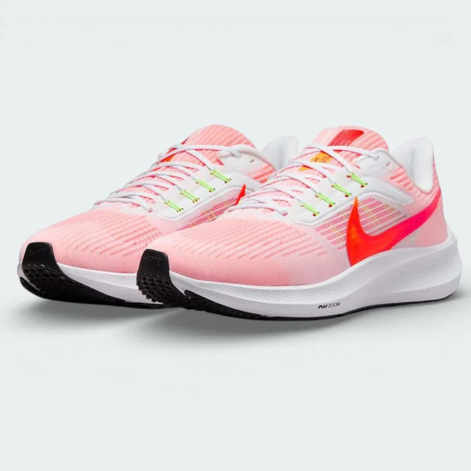 Angled shot of both Nike Pegasus 39 trainers side by side, showcasing the aerodynamic shape and vibrant orange detailing.