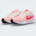 Angled shot of both Nike Pegasus 39 trainers side by side, showcasing the aerodynamic shape and vibrant orange detailing.