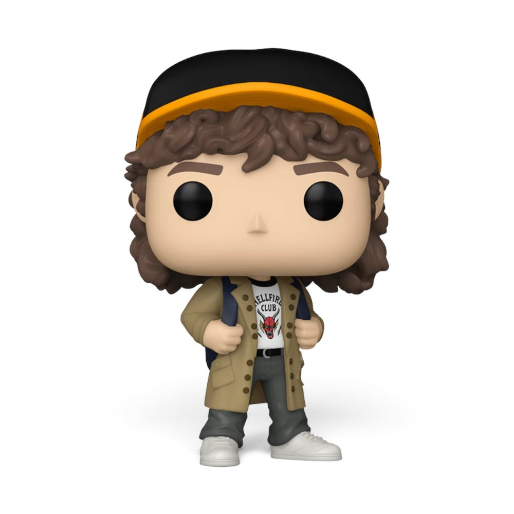 Displays the standalone vinyl figure of Dustin Henderson in a confident stance, featuring his curly brown hair, black and yellow trucker cap, tan coat, white Hellfire Club logo shirt, blue backpack straps, dark grey trousers, and white trainers.