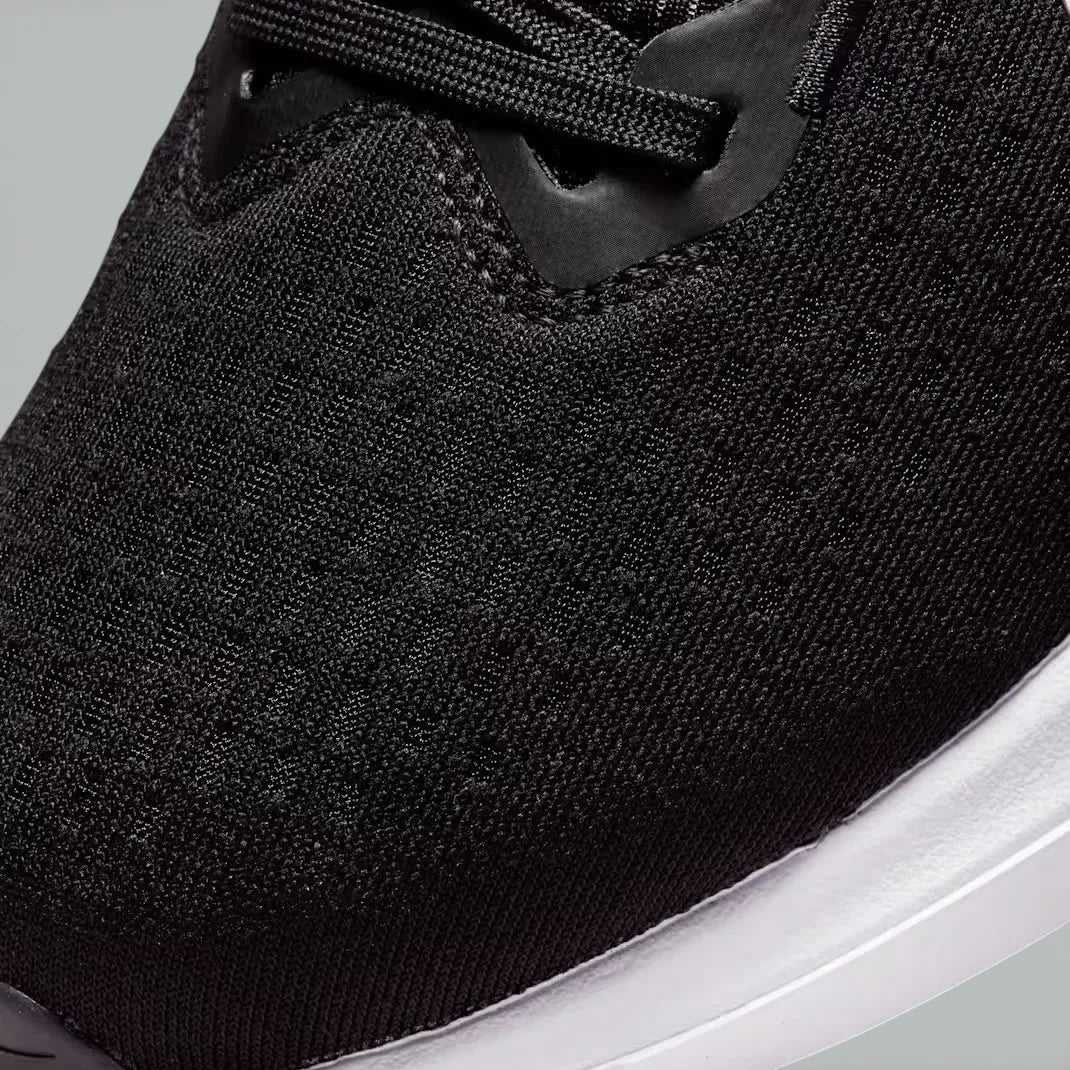 Close-up of the front of the Nike Winflo 10, showing the detail of the engineered mesh and the sturdy lacing system for midfoot support.