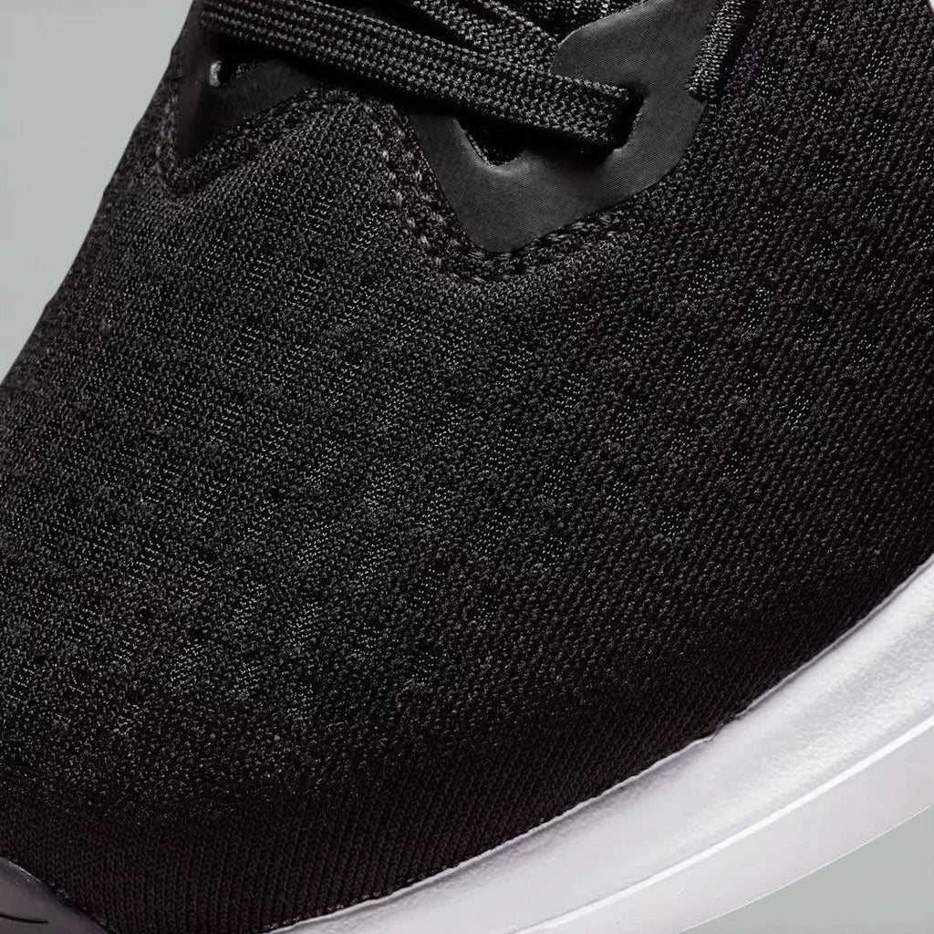 Close-up of the front of the Nike Winflo 10, showing the detail of the engineered mesh and the sturdy lacing system for midfoot support.